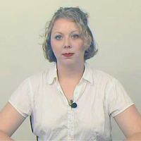 Cindy Fine Woman with short blonde hair wearing a white shirt